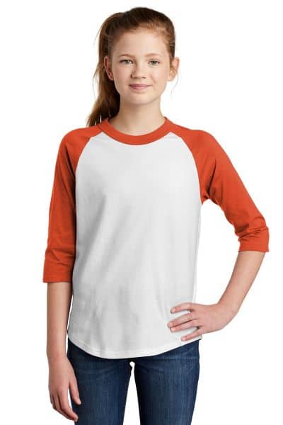 girl wearing baseball raglan tee with white torso and three-quarter dark orange sleeves