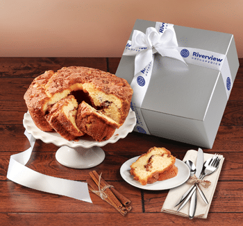 Cinnamon Walnut Coffee Cake in a silver gift box tied with a logoed satin ribbon